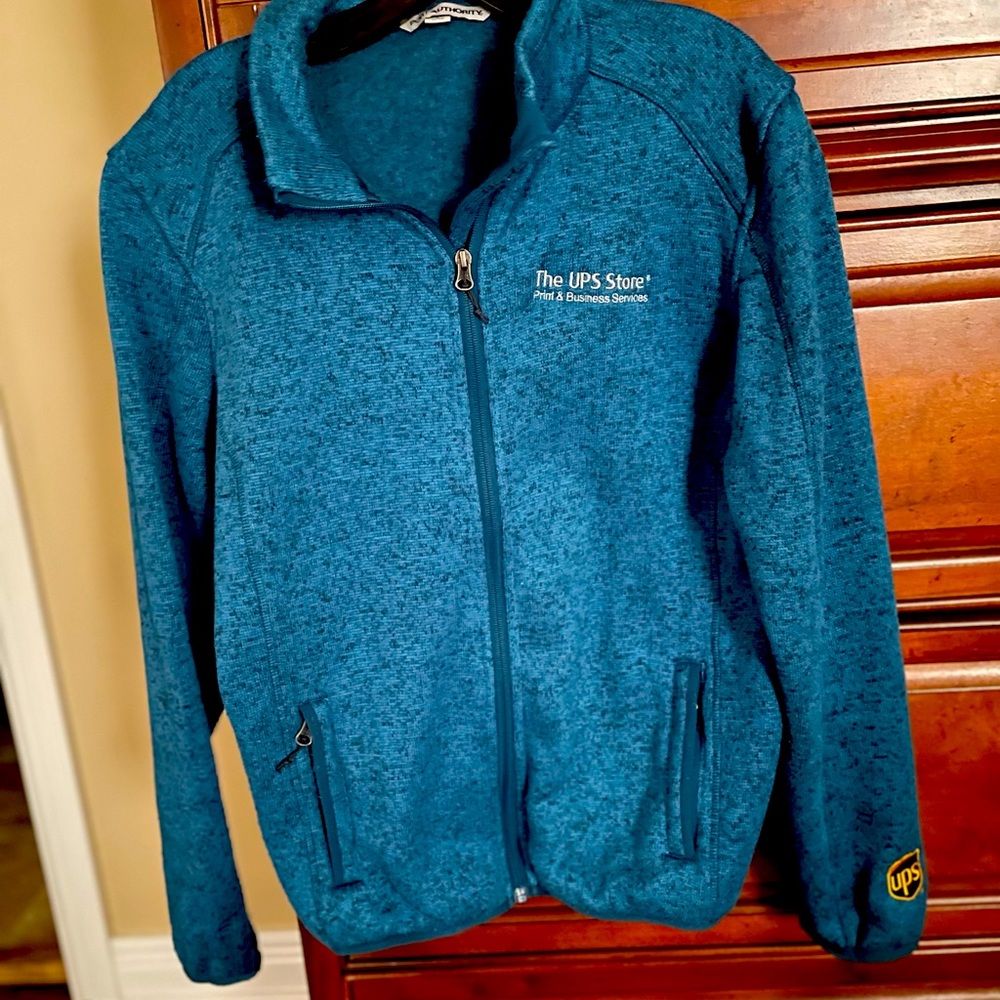 The UPS Store jacket. Large, clean, dark teal nice quality jacket with pockets.